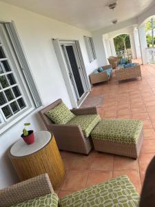 a patio with couches and a table and chairs at Villa Zeddy in Nazareth