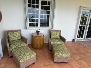 two chairs and a table on a patio at Villa Zeddy in Nazareth +26 photos