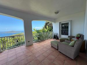 a living room with a balcony with a view of the ocean at Villa Zeddy in Nazareth