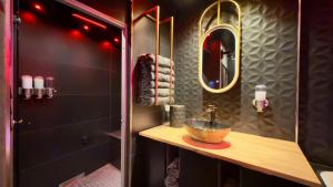 a bathroom with a sink and a mirror at Luxuria - Jacuzzi et Hammam in Le Cannet