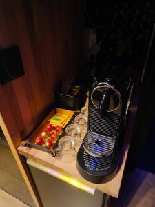 a toaster sitting on top of a table with apples at Luxuria - Jacuzzi et Hammam in Le Cannet