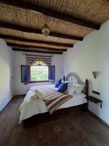 a bedroom with a large bed with a large window at blue moon in Chefchaouen
