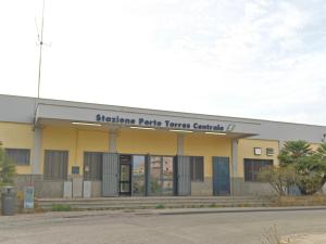 a building with a sign that reads shibuya radio transfer center at B&B Brezza Marina in Porto Torres