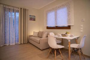 a living room with a table and a couch at Nikoletta 4 in Vlachopoulátika