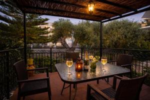 a table with wine glasses on a patio at Nikoletta 4 in Vlachopoulátika