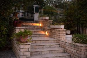 a set of stairs with potted plants and lights at Nikoletta 4 in Vlachopoulátika