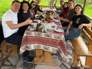 a group of people sitting at a picnic table at Mirage in Shinuhayr +11 photos