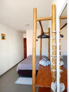 a bedroom with a bed and two bunk beds at Residencial Lucernaré - Tiririca in Itacaré