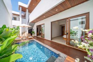 an indoor swimming pool in a villa at Cassandra Villas - Tropical Private Pool Escape near Beach in Sanur