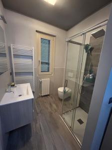 a bathroom with a glass shower and a sink at Franciacorta Garden House in Cazzago San Martino +7 photos