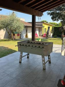 a ping pong table sitting on a patio at Franciacorta Garden House in Cazzago San Martino