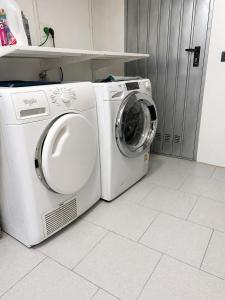 a white washer and dryer in a room at Franciacorta Garden House in Cazzago San Martino