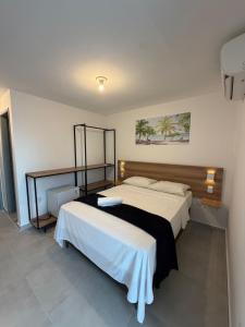 ein Schlafzimmer mit einem Bett mit einer schwarz-weißen Decke in der Unterkunft Hotel Pousada Sol Beira-mar in Natal