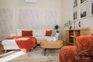 a living room with a couch and a table at Rá-Cozy in Pécs +32 photos