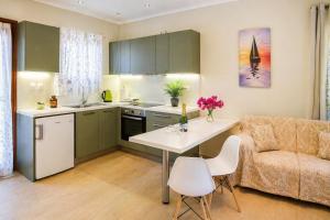 a kitchen and living room with a table and a couch at Nikoletta 5 in Vlachopoulátika