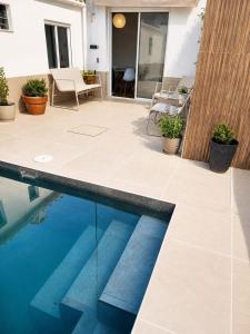 a patio with a swimming pool and some plants at House with a private pool, relaxation guaranteed in Talavera de la Reina