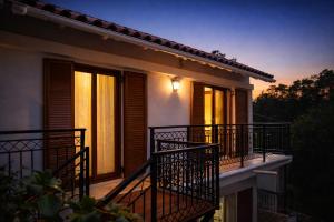a balcony of a house at night with lights at Nikoletta 5 in Vlachopoulátika