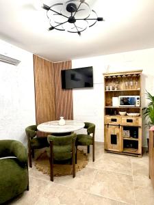 a dining room with a table and chairs and a tv at Casa Natali 2 in Fuengirola