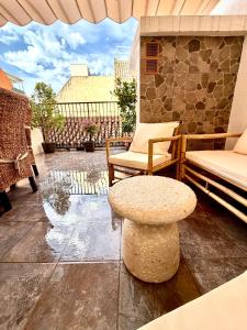 a patio with a bench and a table and chairs at Casa Natali 2 in Fuengirola
