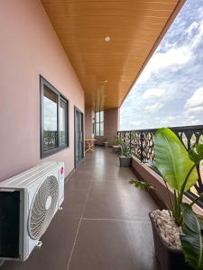 a room with a balcony with a fan and plants at Les Résidences AKATA-Appartement HOUÈ in Abomey-Calavi