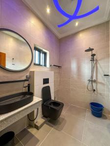 a bathroom with a toilet and a sink and a mirror at Les Résidences AKATA-Appartement HOUÈ in Abomey-Calavi +12 photos