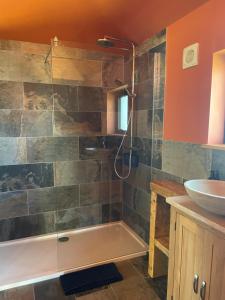 a bathroom with a tub and a sink at Zambezi Cabin in Halesworth