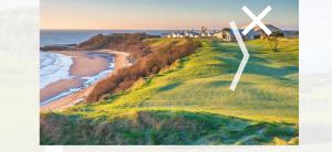 a windmill on a golf course next to the ocean at Golf central in Rosslare Harbour