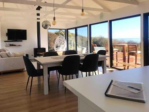 a dining room and living room with a table and chairs at Stokes Bay Cliffs Kangaroo Island in Stokes Bay