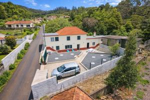 an aerial view of a house with a car parked in a driveway at Santo Wellness Villa by Mth in Santo António da Serra
