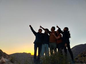 a group of people standing on top of a mountain at Alojamiento y Refugio Cósmico Torreon in Comunidad Campo de Ahumada