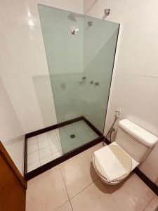 a bathroom with a shower and a toilet at Hotel Mata da Praia in Vitória
