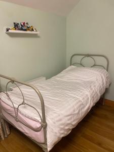 a bed in a bedroom with a shelf on the wall at Hunthill in Tulach an Iarainn
