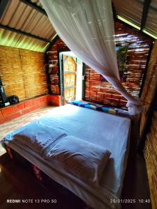 a large bed in a room with a window at Ecopradera Lodge in San José del Guaviare +47 photos