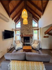a living room with a couch and a fireplace at Ayelen Andina in Esquel