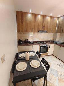 a small kitchen with a table and chairs in it at App najoua in Safi