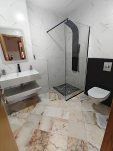 a bathroom with a shower and a toilet and a sink at App najoua in Safi +19 photos