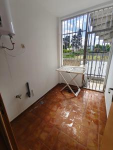 an empty room with a table and a large window at App najoua in Safi
