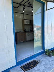 a view of a kitchen from the inside of a house at Casa Container Completa e Privativa em Sombrio-SC in Sombrio +4 photos