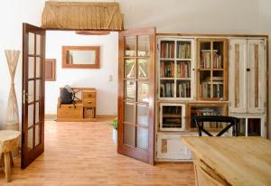 a living room with a book shelf and a table at Step by Step Atlantic Guesthouse in Vila do Conde