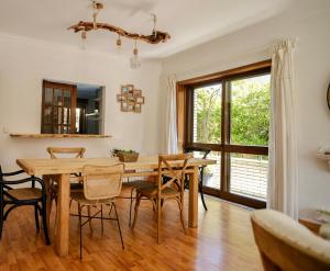 a dining room with a table and chairs and a window at Step by Step Atlantic Guesthouse in Vila do Conde