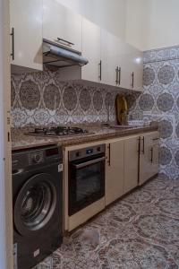 a kitchen with a stove and a washing machine at COZY APPARTEMENT Center city 11 janvier in Casablanca +8 photos