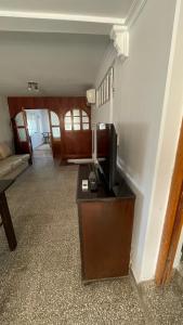 a living room with a television on a table at Casa Rivadavia in Rafaela