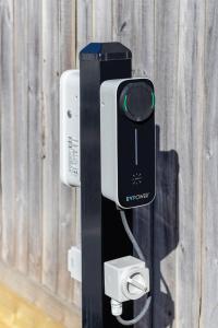 a cell phone is attached to a wall at Waves & Wellness - Spa Pool and Parking in Christchurch