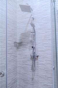 a shower with a shower head in a bathroom at COZY APPARTEMENT Center city 11 janvier in Casablanca
