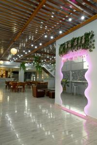 a lobby with a pink sign on a wall at Terra Premium Hotel in Huánuco