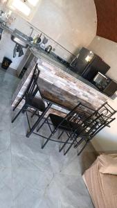 a kitchen with a counter with a table and chairs at Kenzy House Abu Simbel in Abu Simbel