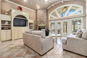 a living room with two couches and a tv at Casa Oasis Extra Large home centrally located in Springdale