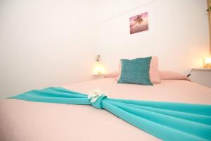 a bed with a blue dress on top of it at Ocean Paradise View in Adeje +30 photos