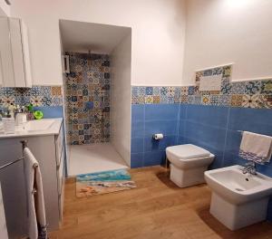 a bathroom with a toilet and a sink at Oikos Terrasini in Terrasini +28 photos