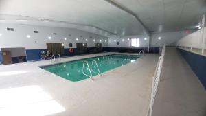 a large swimming pool in a large room with at Home Place Suites in Bartlesville